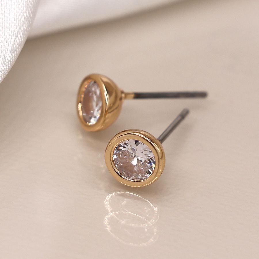 Gold-plated round stud earrings with clear crystal accents by POM Jewellery, featuring a simple, elegant design.