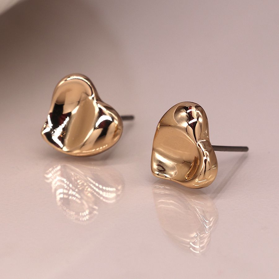 Gold wavy heart stud earrings from POM Jewellery by Cornucopia Home and Gift, featuring a shiny, heart-shaped design.