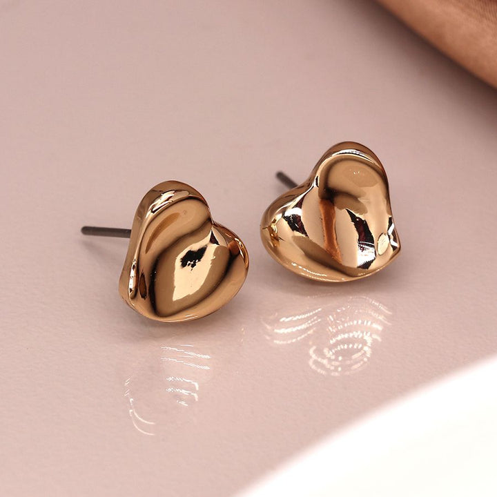 Gold wavy heart stud earrings by POM Jewellery featuring a delicate heart shape with a shiny gold finish.