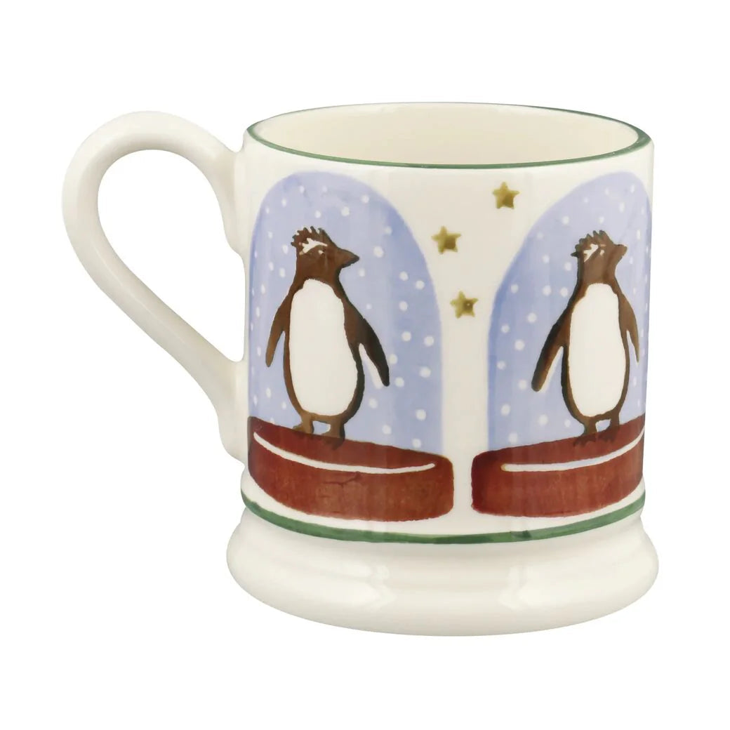Emma Bridgewater Penguin Snow Globe Half Pint Mug featuring a festive snow globe design with penguins, perfect for Christmas decor.