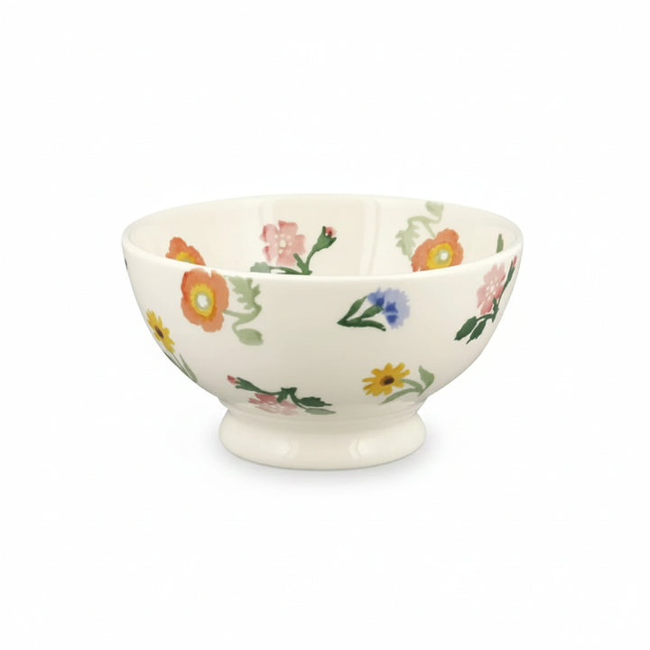 Small white footed bowl with floral design on a white background