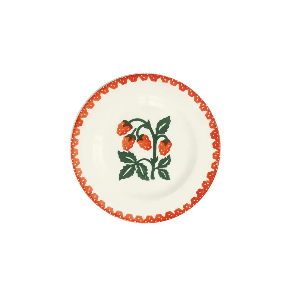 A white ceramic plate with a red border and a floral pattern in the center, featuring raspberries.