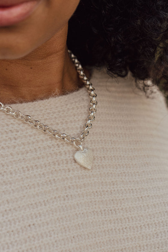 Silver Solace Necklace by Tutti &amp; Co featuring a delicate pendant on a fine chain, styled with a neutral background.