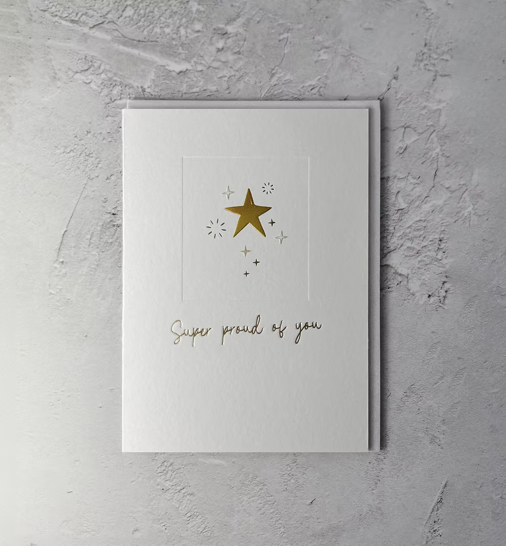 Heyy Copacetic "Super Proud of You" greeting card by Cornucopia Home and Gift, featuring colorful handwritten text on a cheerful background.