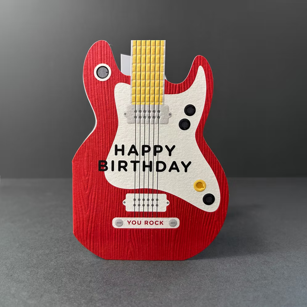 Taking Shape Guitar Happy Birthday Card by Cornucopia Home and Gift, featuring colorful guitar illustration on a cheerful greeting card