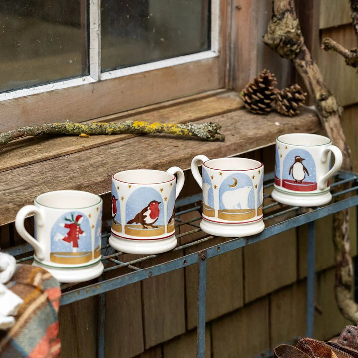 Emma Bridgewater Polar Bear Snow Globe Half Pint Mug featuring a festive snow globe design with a polar bear scene.