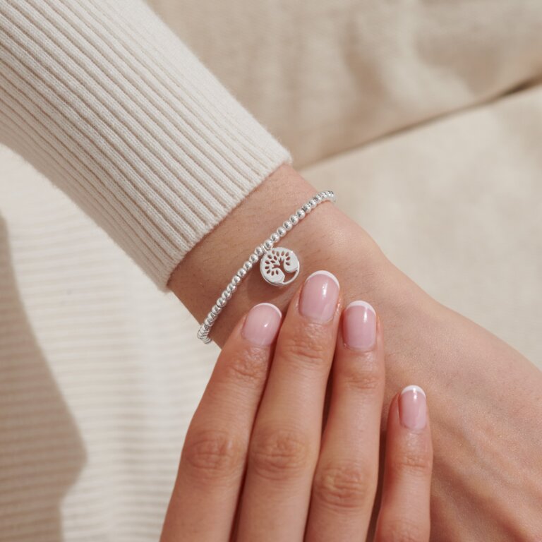 Joma Jewellery A Little 'Family' bracelet with silver and gold-tone charms on a delicate chain, showcasing a meaningful accessory.