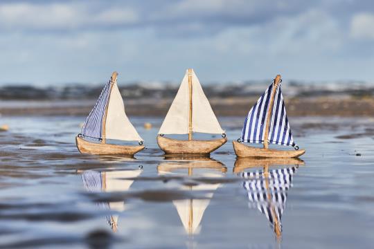 Colorful Nautico ship with double sails, part of IB Laursen Summer collection by Cornucopia Home and Gift, displayed in vibrant assorted colors.