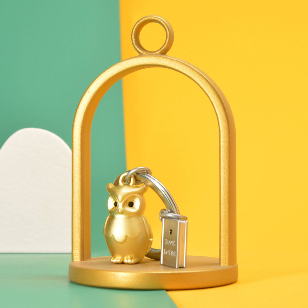 Gold owl and book keyring by Oli Olsen featuring a detailed owl charm and miniature book, perfect for keys or accessories.
