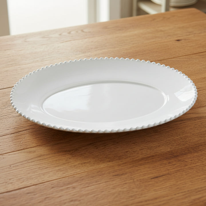 Large pearl white oval platter by Cornucopia Home and Gift, featuring a smooth, elegant ceramic surface for serving.