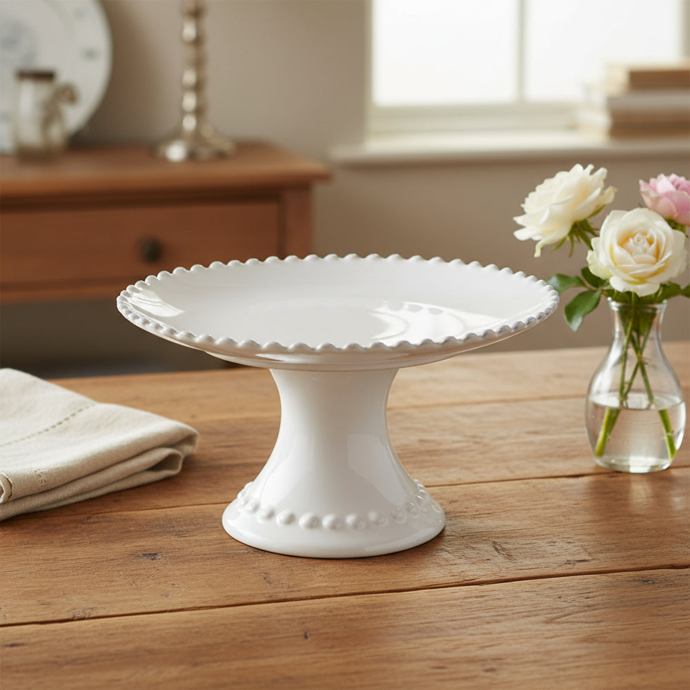 Small pearl white footed plate from Cornucopia Home and Gift's My Gifts Trade collection, featuring a delicate ceramic design.
