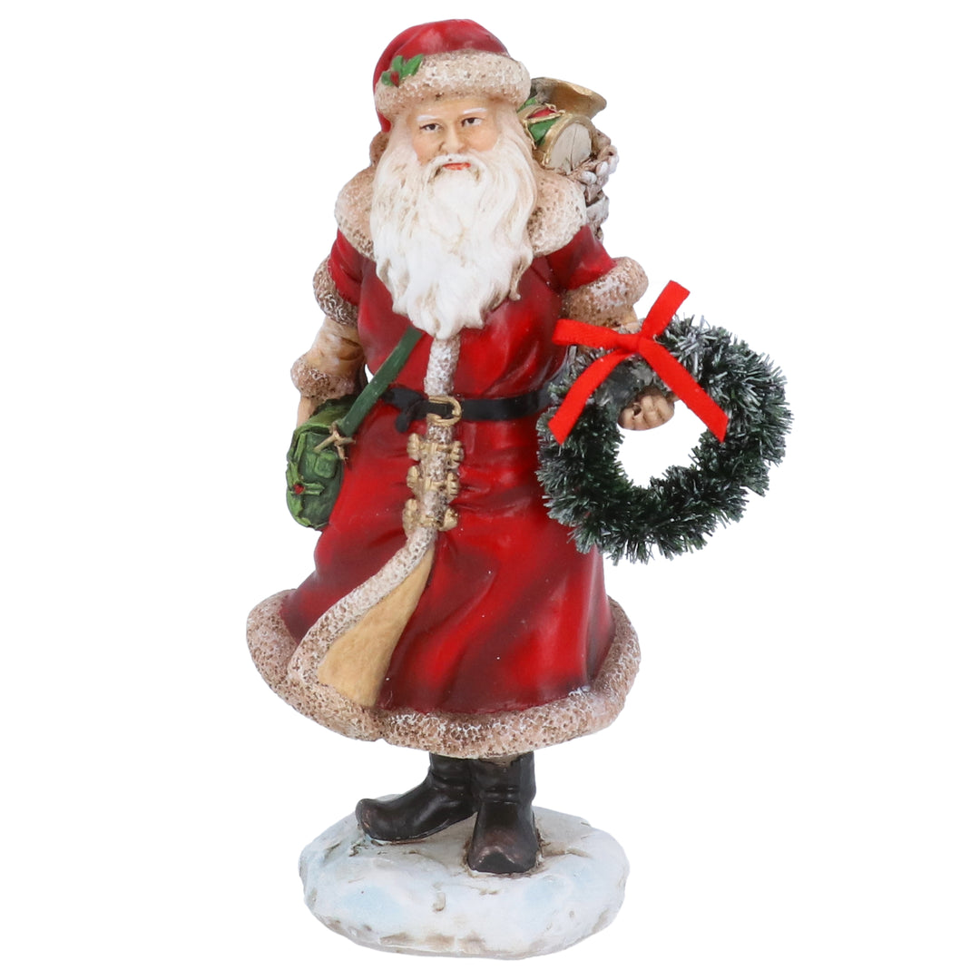 Resin Santa ornament holding a wreath, Gisela Graham Christmas decoration, ideal for holiday decor and festive displays.