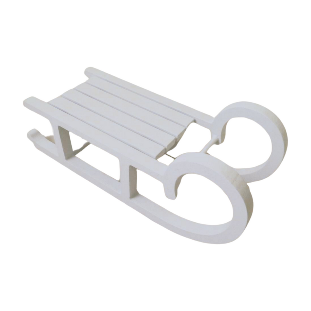 Large white wooden sleigh from Cornucopia Home and Gift, Christmas giftware trading decor, with detailed wooden construction.
