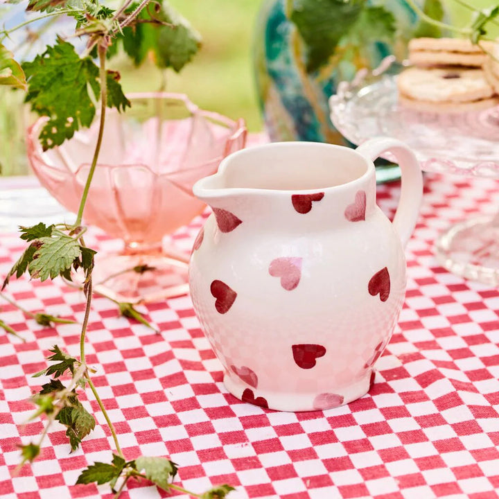 Emma Bridgewater pink hearts half pint ceramic jug with a charming heart pattern on a white background.