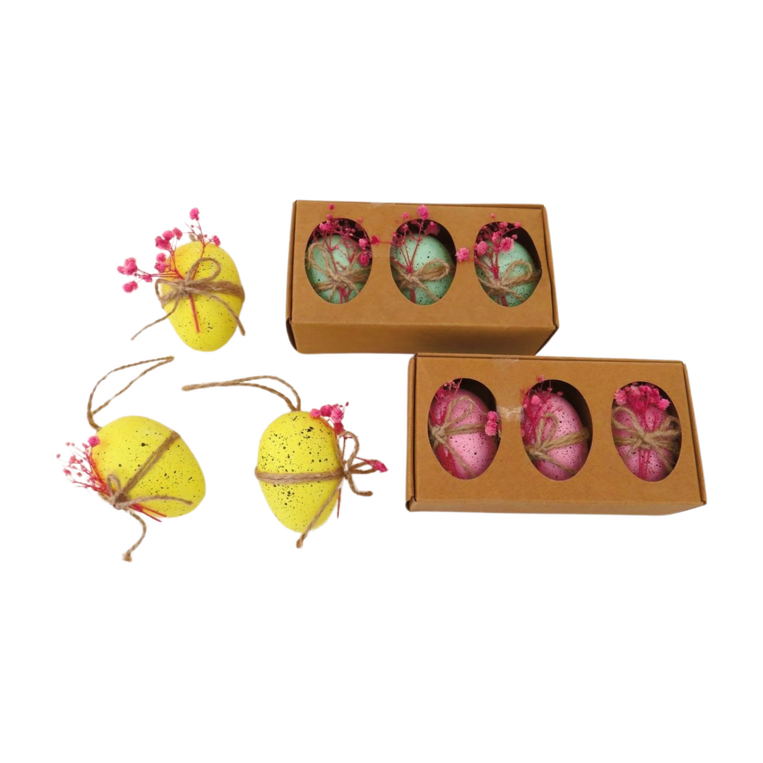 Set of three colorful decorative eggs with dried flowers by Cornucopia Home and Gift, perfect for giftware or home decor.