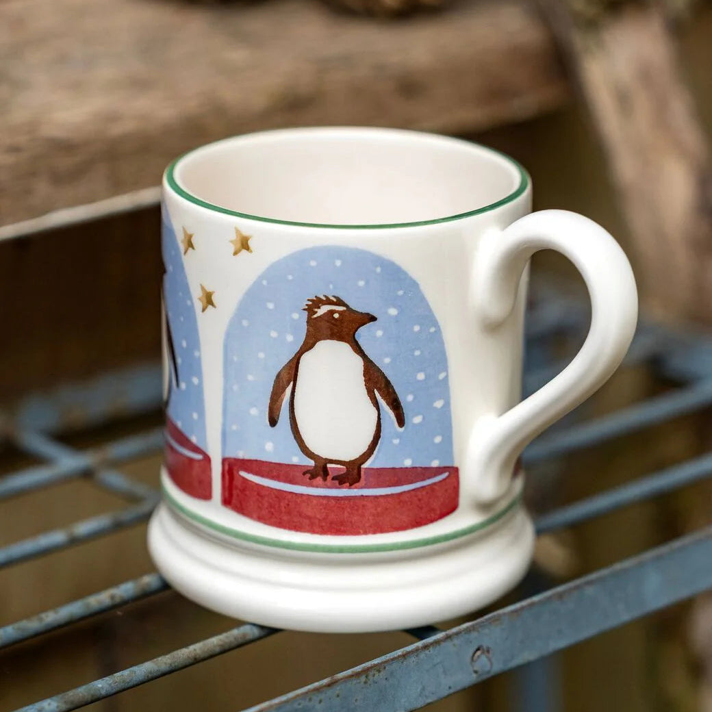 Emma Bridgewater Penguin Snow Globe Half Pint Mug featuring festive penguin and snow globe design, perfect for Christmas celebrations.