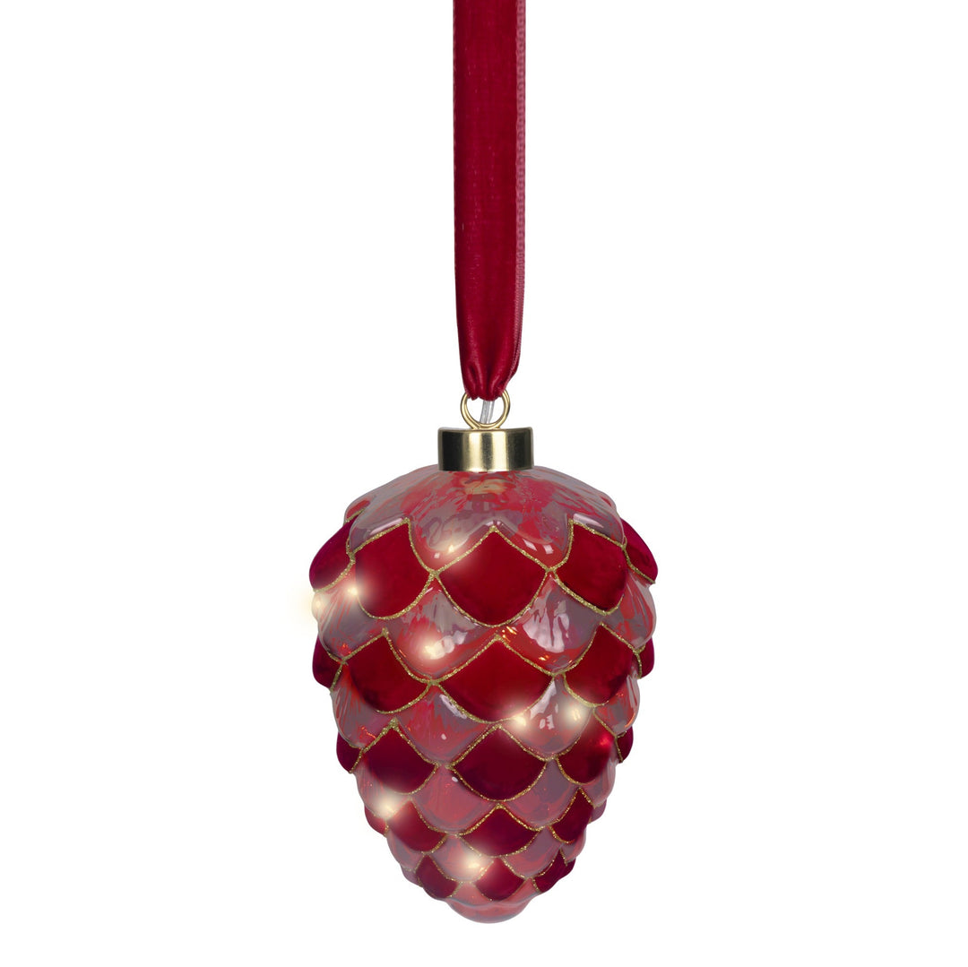 A red pinecone-shaped Christmas ornament with a glossy finish, gold trim, and built-in warm white lights, hanging from a red ribbon on a white background.