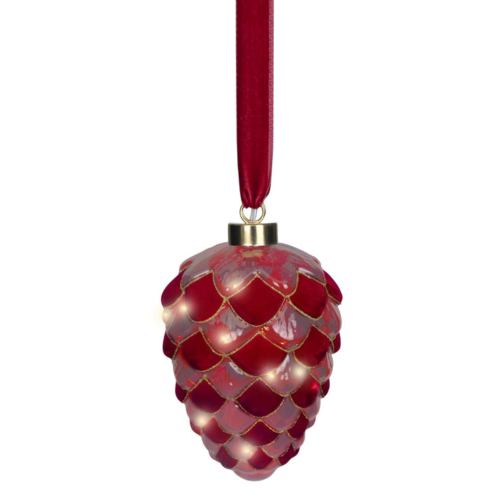 A red pinecone-shaped Christmas ornament with a glossy finish, gold trim, and built-in warm white lights, hanging from a red ribbon on a white background.
