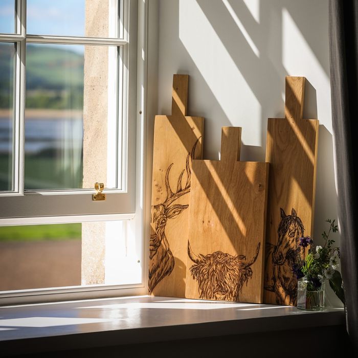 Large Highland Cow oak serving paddle from Selbrae House, featuring detailed Highland Cow design, ideal for serving cheeses or charcuterie.