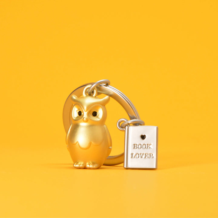 Gold Owl and Book keyring by Oli Olsen featuring a detailed owl and open book charm, ideal for keys or bags.