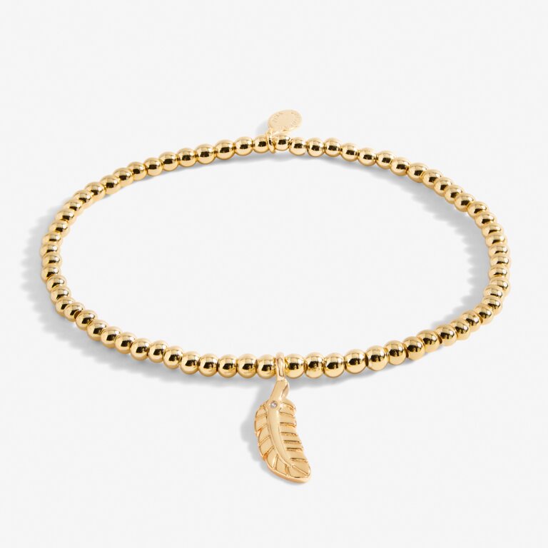 Gold "A Little Feathers Appear" bracelet by Joma Jewellery featuring delicate feather charms on a gold chain.