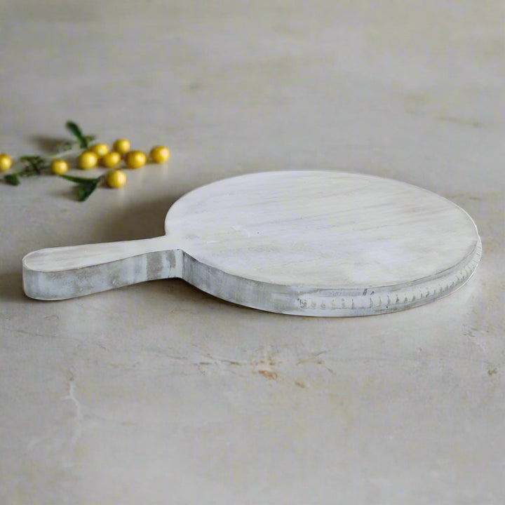 Large beaded mango wood chopping board by Cornucopia Home and Gift, featuring a decorative beaded edge and smooth cutting surface.