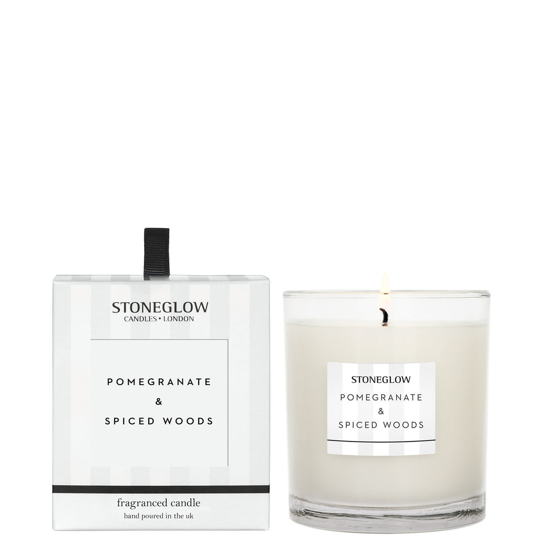 Stoneglow Modern Classics Pomegranate and Spiced Woods boxed tumbler candle with a decorative label and warm-toned packaging.
