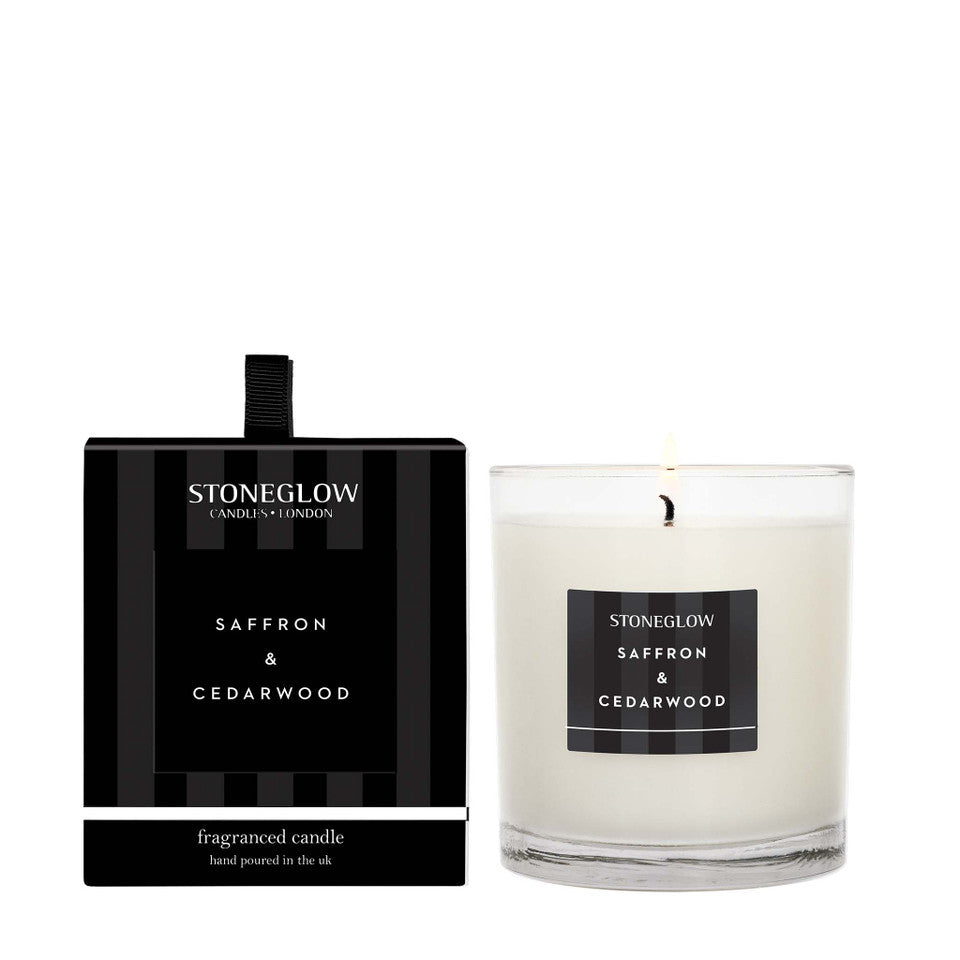 Stoneglow Saffron and Cedarwood scented candle in a boxed tumbler by Cornucopia Home and Gift, with warm amber-colored wax and elegant packaging.