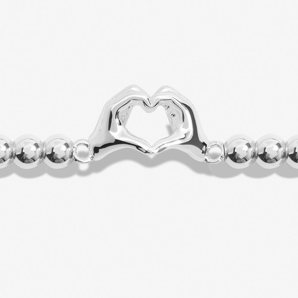 Joma Jewellery Friendship Bracelet with charms symbolizing laughter, happiness, and friendship, featuring colorful beads and a silver-tone clasp.