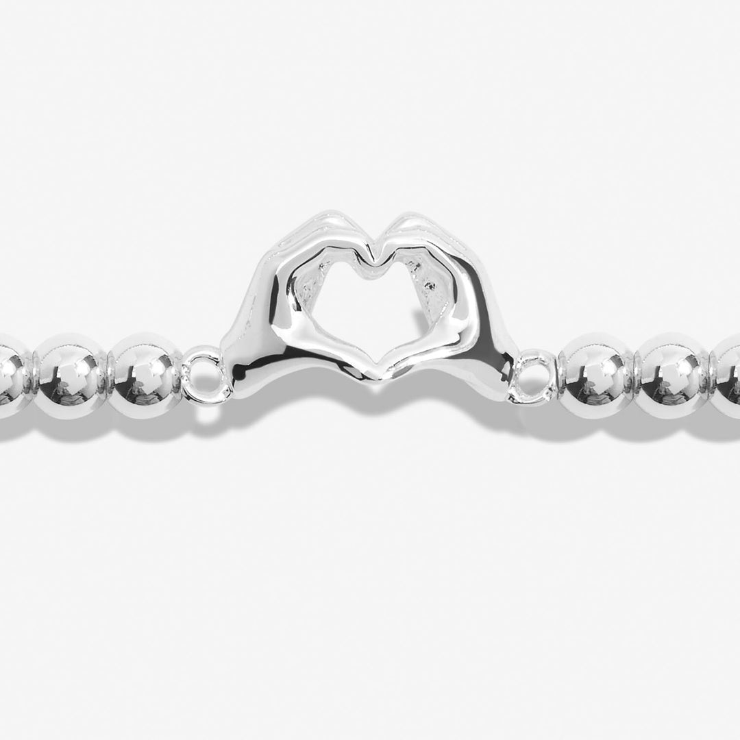 Joma Jewellery Friendship Bracelet with charms symbolizing laughter, happiness, and friendship, featuring colorful beads and a silver-tone clasp.