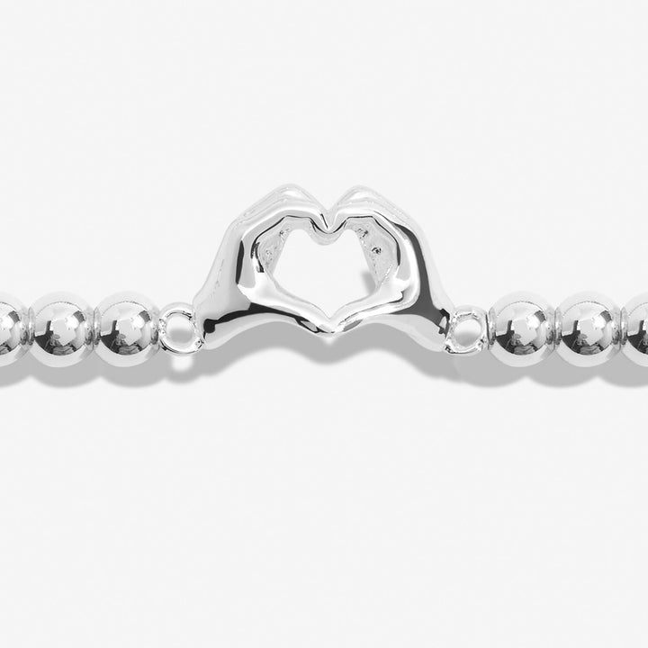 Joma Jewellery Friendship Bracelet with charms symbolizing laughter, happiness, and friendship, featuring colorful beads and a silver-tone clasp.