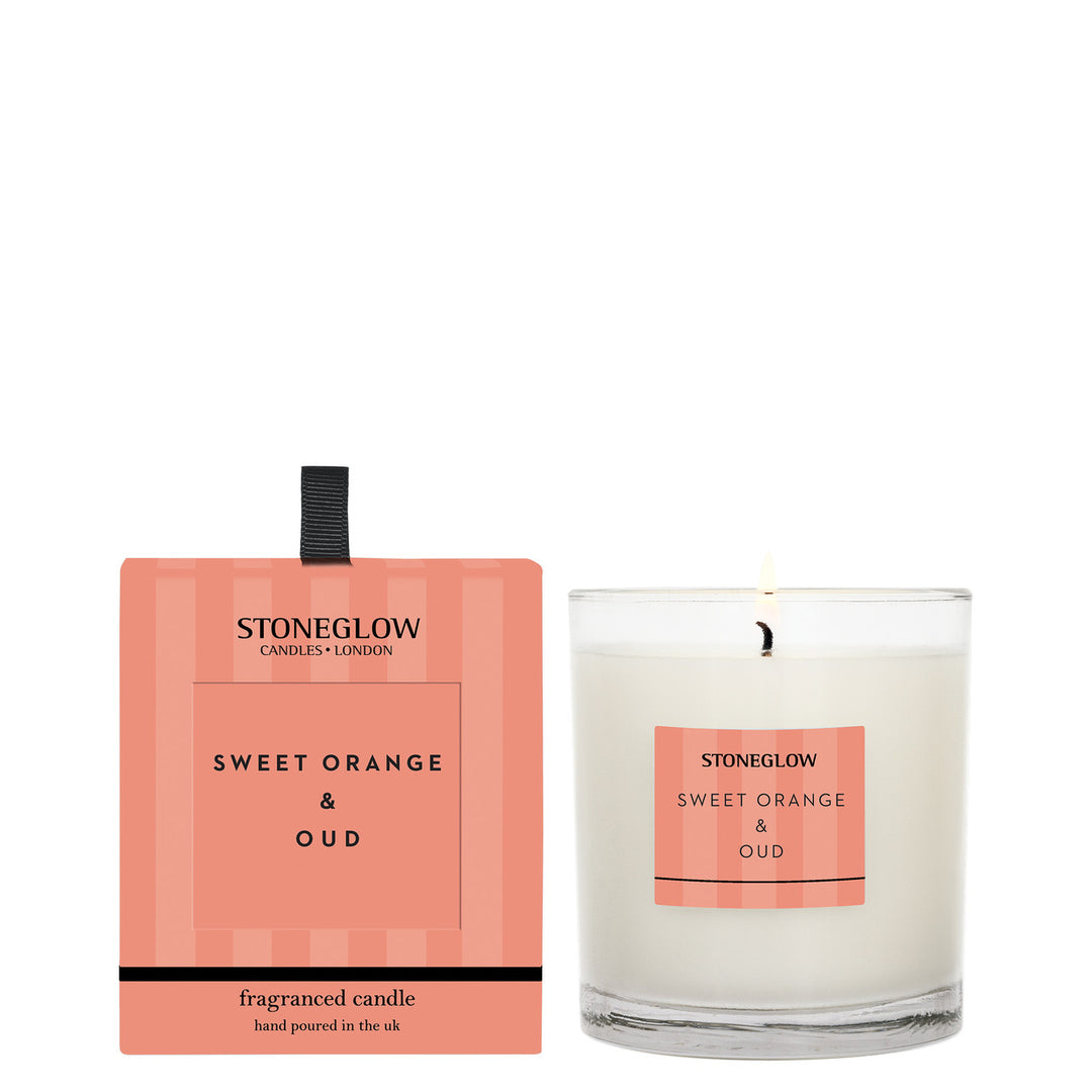 Stoneglow Modern Classics Sweet Orange and Oud tumbler candle with orange and wood-inspired design.