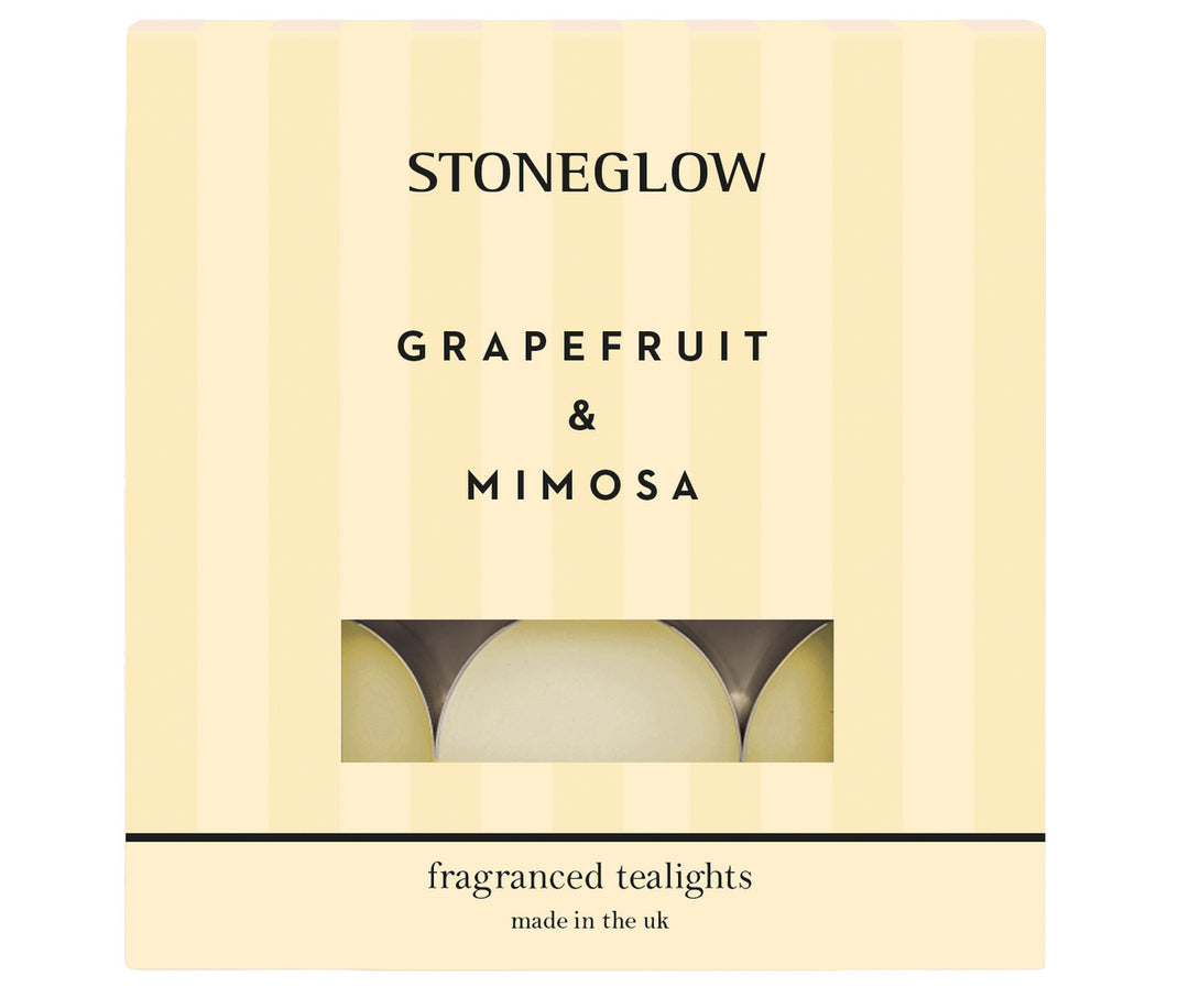 Set of Stoneglow grapefruit and mimosa scented tealights in clear holders, perfect for creating a warm, fragrant ambiance.