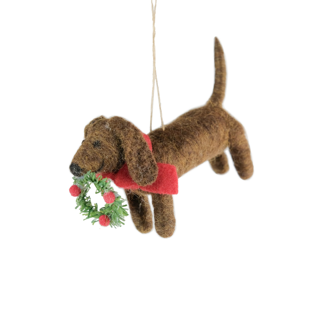 Felt dog carrying wreath Christmas decoration by Cornucopia Home and Gift, Ascalon Christmas themed, with festive holiday design.