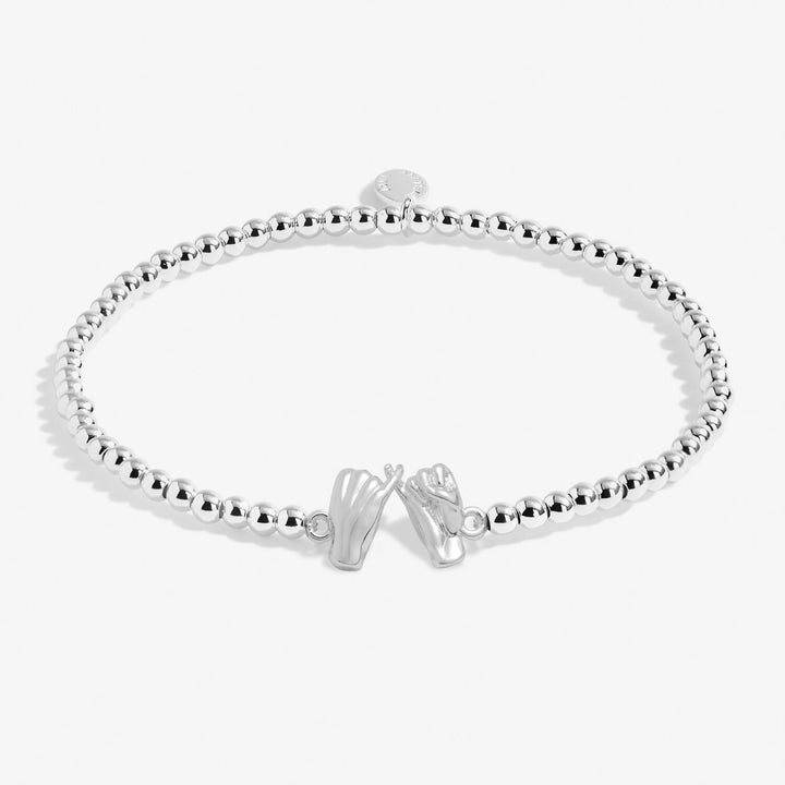 Pink Joma Jewellery Little Pinky Promise bracelet with delicate charm on a soft pink strap, perfect for stacking or gifting.