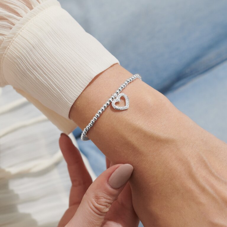 Silver "A Little Sister" bracelet by Joma Jewellery featuring delicate chain and engraved charm, designed for sister gift.