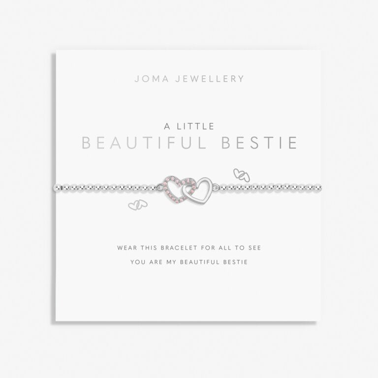 Close-up of a delicate Joma Jewellery "A Little Beautiful Bestie" bracelet with charm and beaded details, on a neutral background.