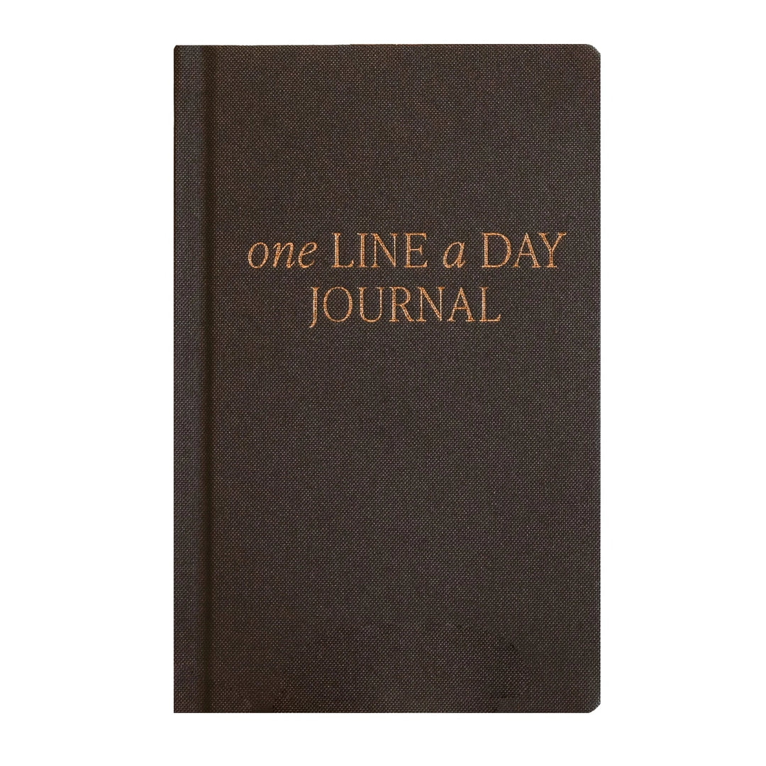 A dark brown hardcover journal with gold foil text reading &