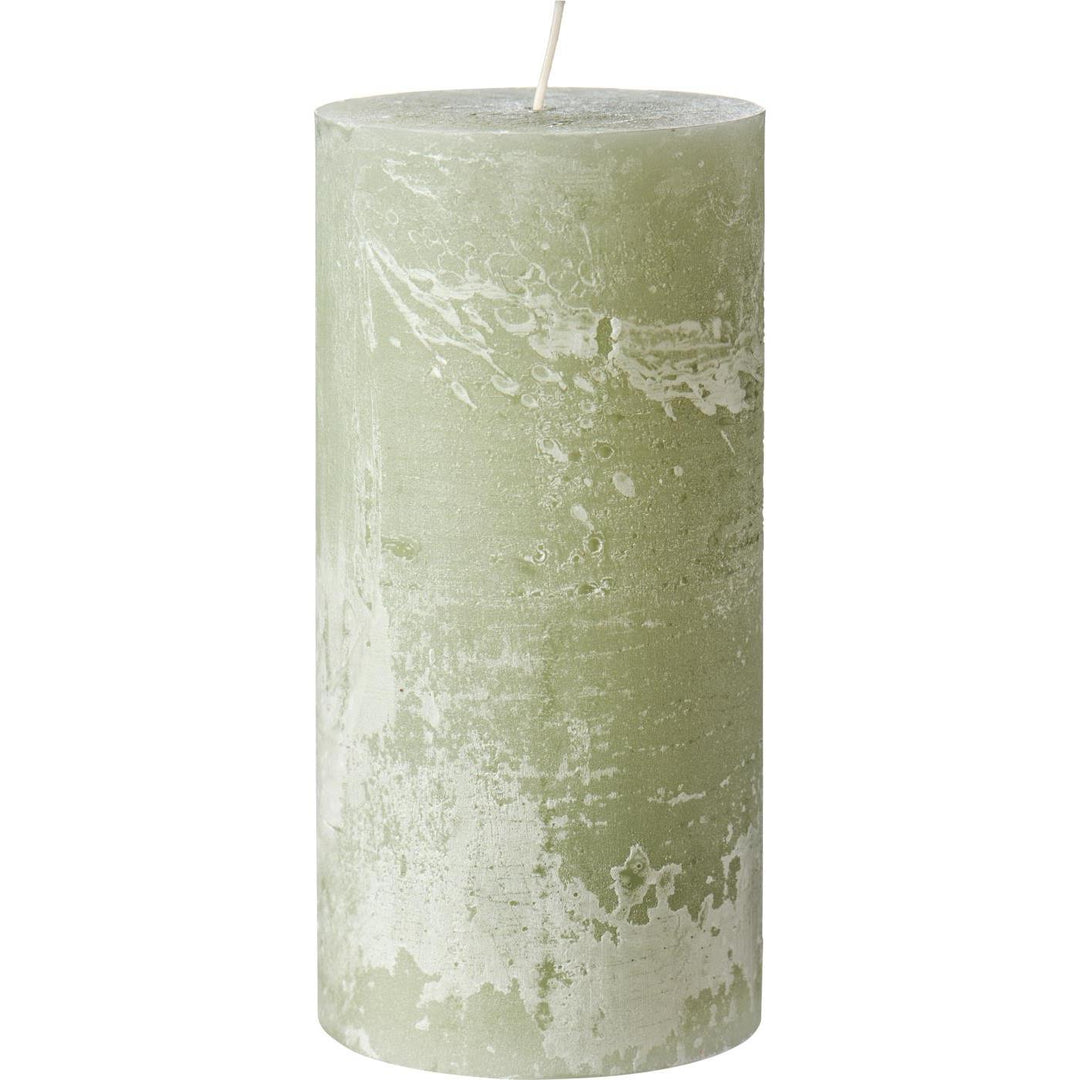 IB Laursen Rustic Green Tea Pillar Candle from the Summer collection, displayed on a wooden surface with a cozy, rustic setting.