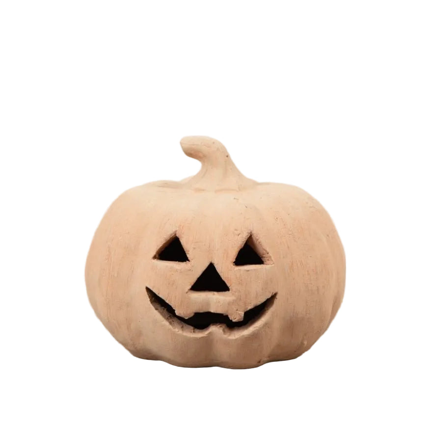 A small unpainted terracotta pumpkin decoration with a carved jack-o&