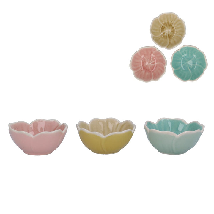Set of three ceramic bowls in pastel colors with floral designs on a white background.