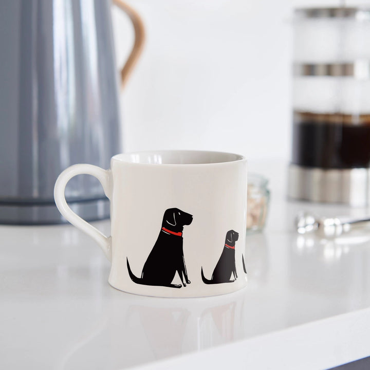 Black Labrador dog mug by Sweet William featuring a realistic black Labrador illustration on a ceramic coffee mug.