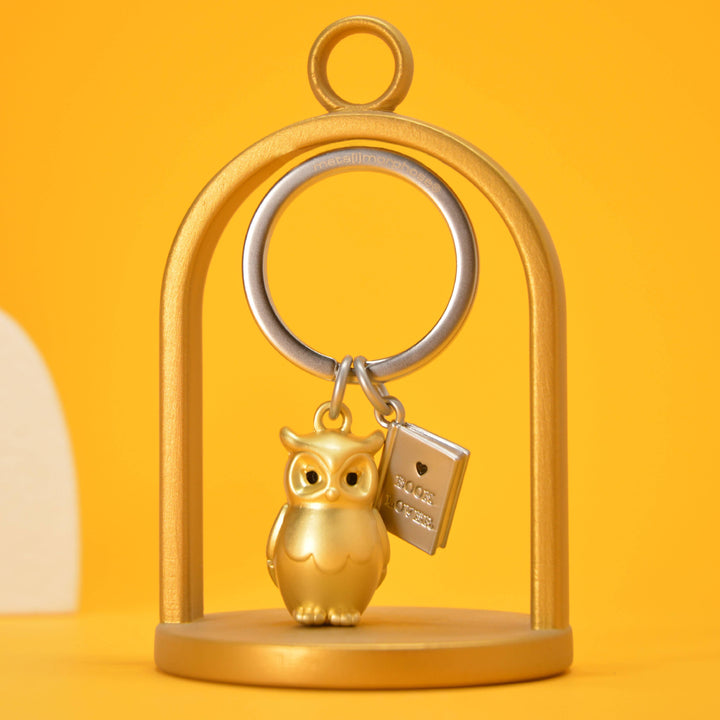 Gold owl and book keyring by Oli Olsen featuring a detailed owl charm and miniature book, perfect for keys or bags.