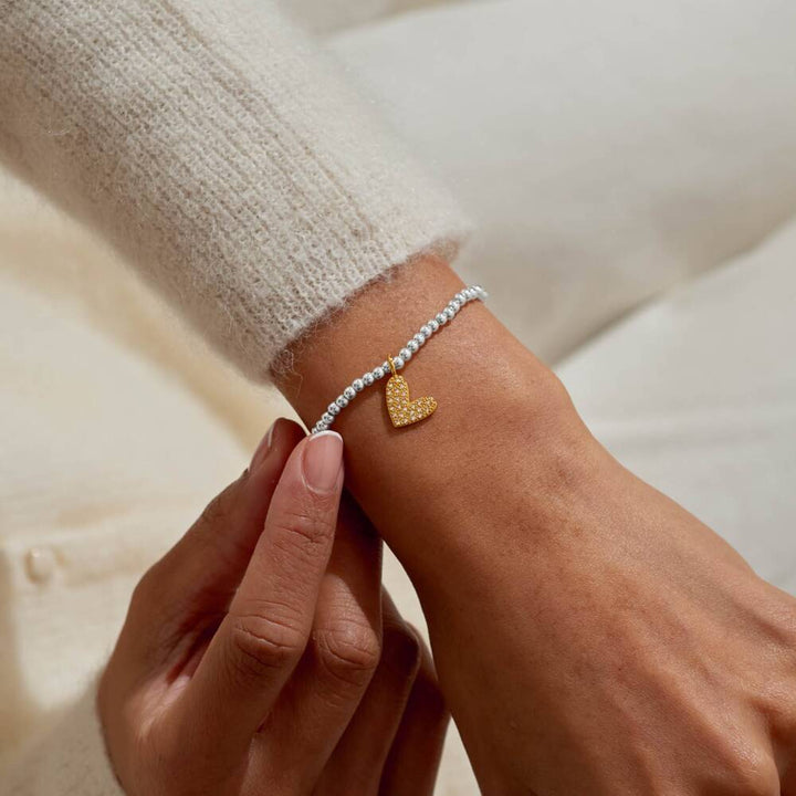Joma Jewellery Little Love You To Bits bracelet with delicate charms on a silver chain, showcasing a charming and sentimental design.