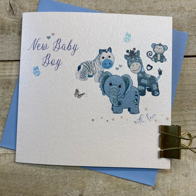 White cotton baby boy greeting card featuring blue toys, by Cornucopia Worcester, with colorful illustrations on the front.
