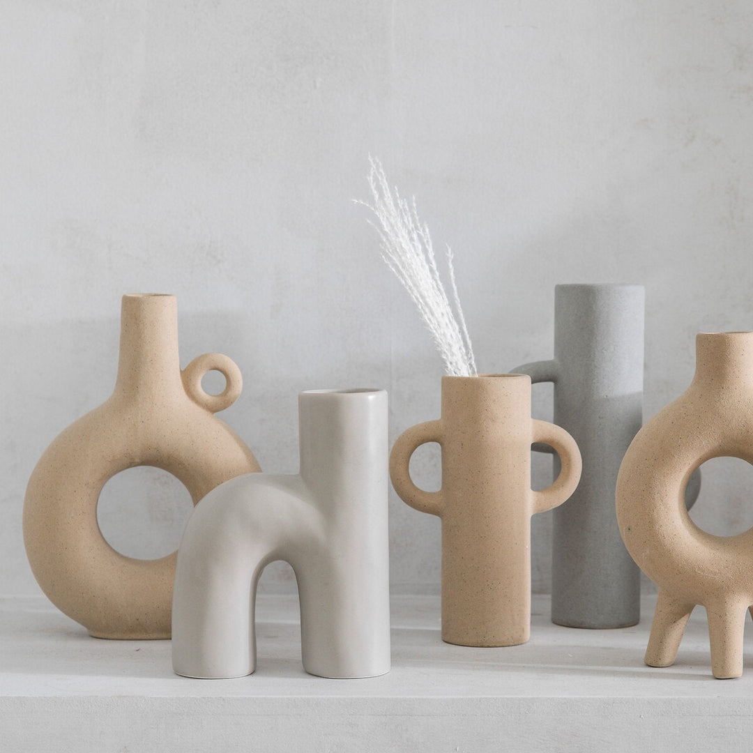 Small Sigga Vase by Cornucopia Home and Gift, oatmeal-colored ceramic gallery vase with a smooth finish and modern design.