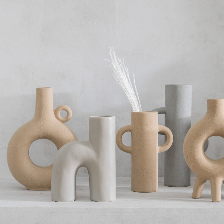 Small Sigga Vase by Cornucopia Home and Gift, oatmeal-colored ceramic gallery vase with a smooth finish and modern design.