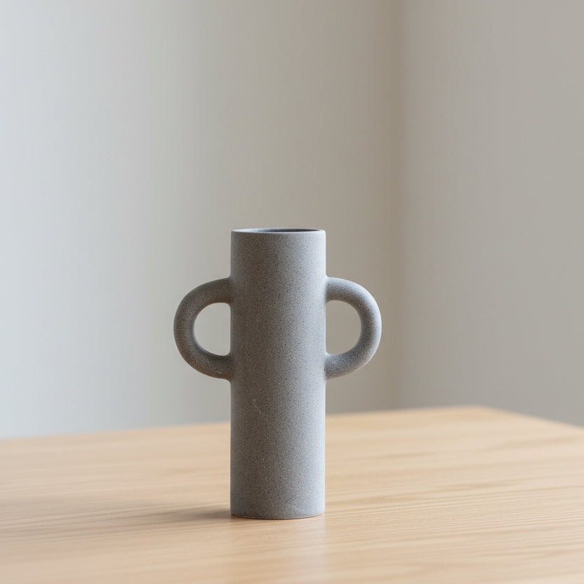 Small Sigga Vase by Cornucopia Home and Gift in light grey with a sleek, modern gallery style design.