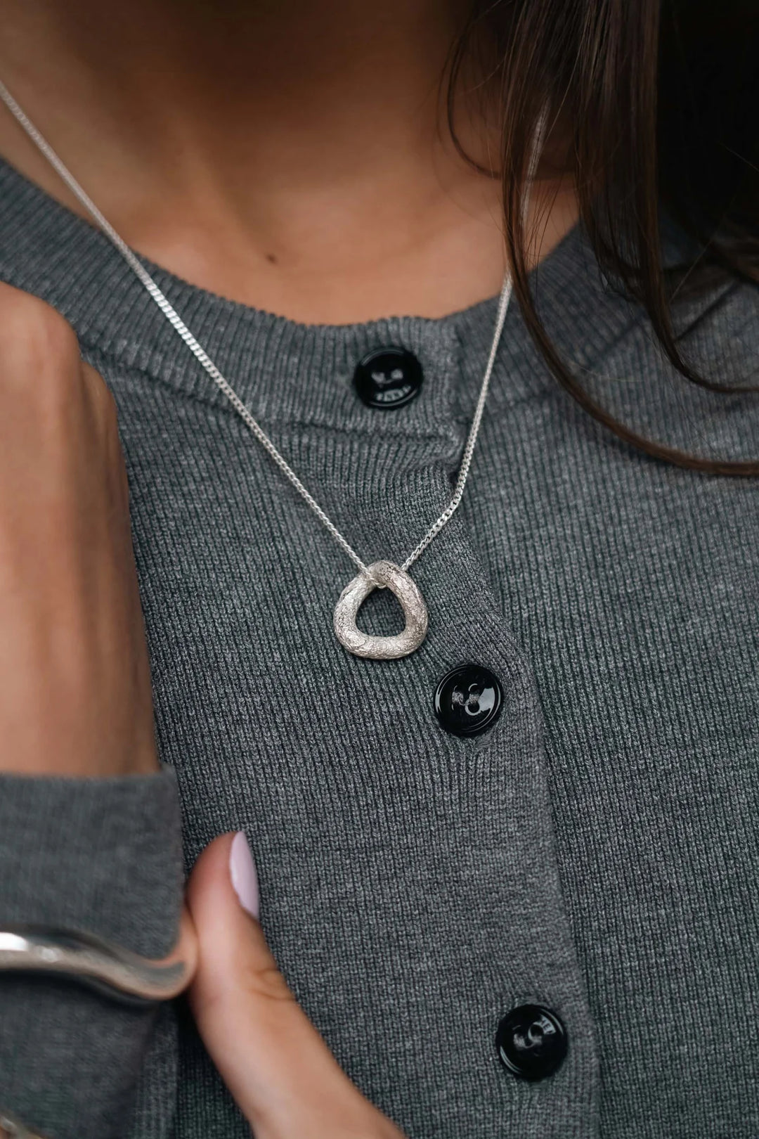 Silver Shadow Necklace by Tutti & Co featuring a delicate chain and shadow-inspired pendant, displayed on a neutral background.