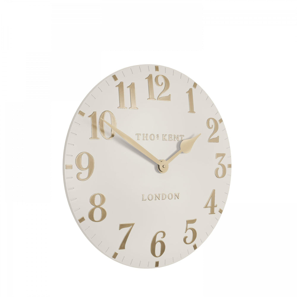 12-inch Arabic wall clock in oatmeal color by Cornucopia Home and Gift, featuring stylish Arabic numerals on a modern clock face.